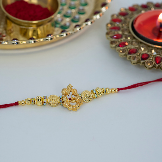Gold Cutout Ganesha with Red Designer Rakhi